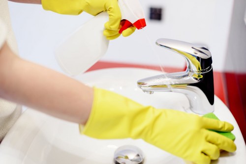Glossy Cleaners team sanitizing kitchen area